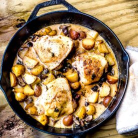 Gluten free chicken marsala in a cast iron skillet on the table.