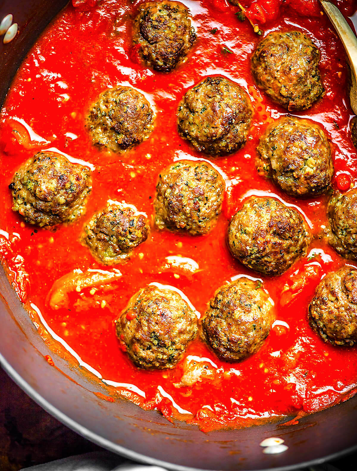 Gluten-free meatballs in a skillet with tomato sauce.