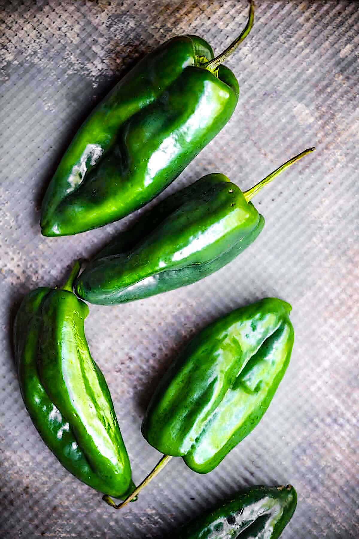 Poblano peppers on a baking pan.